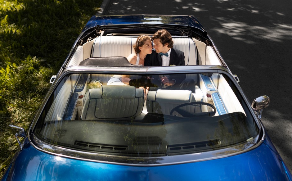 high angle married couple car